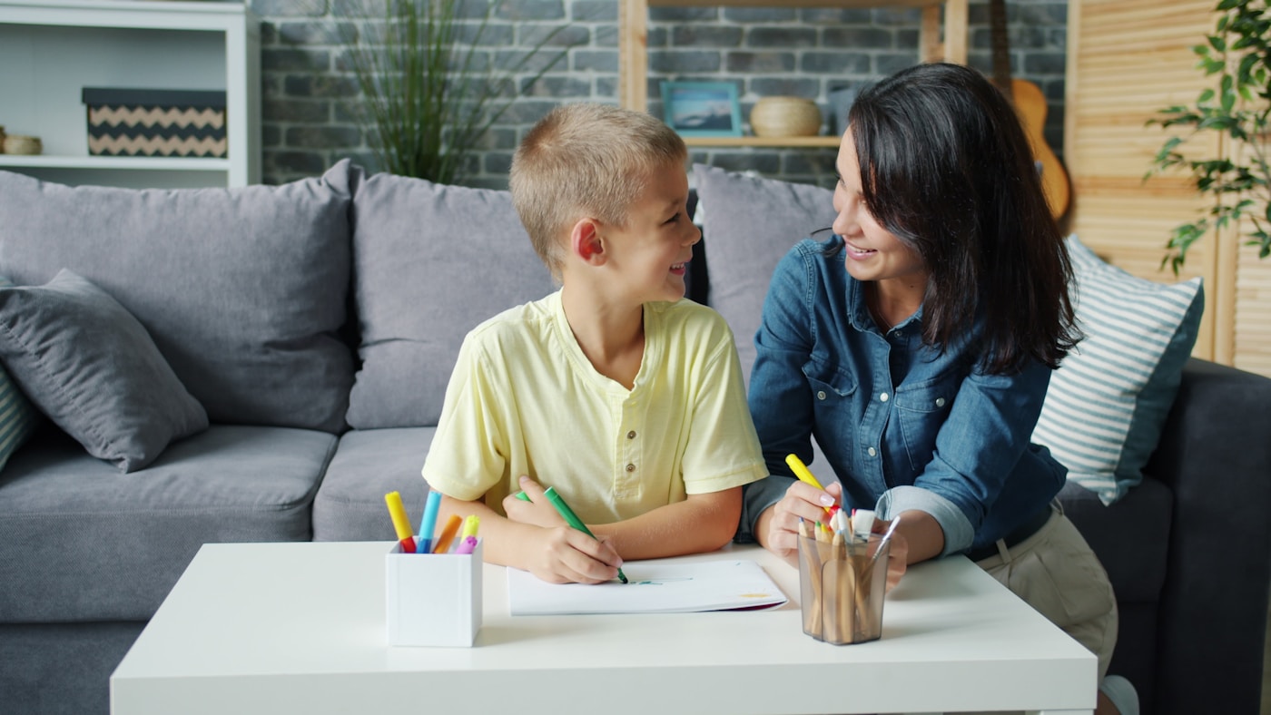 A parent and school-age child sharing a relaxed activity
